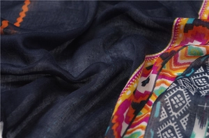 Macro shot showing the texture of ethnic print shawl with vibrant geometric borders