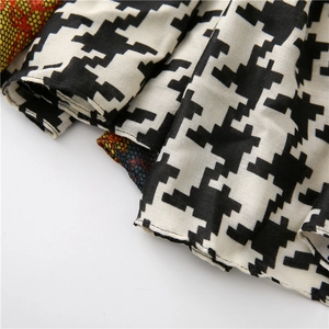 Detail of houndstooth pattern and honeycomb texture on soft cotton linen long scarf