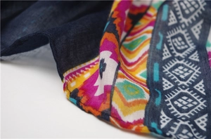 Detailed macro view of bohemian shawl fabric with colorful geometric print and tassels