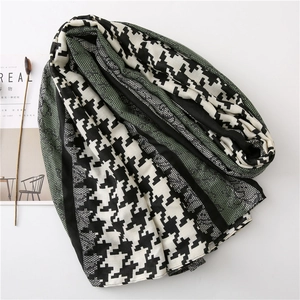 Detail of houndstooth scarf with dark green mesh lace stitching and linen feel texture