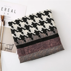 Detail of houndstooth scarf with elegant lace patchwork and striped pattern on white
