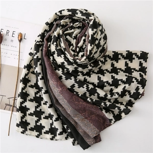 Close-up of houndstooth scarf with lavender honeycomb print and delicate lace texture