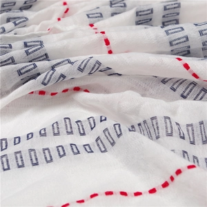 White cotton linen scarf with blue geometric patterns and red stitching detail