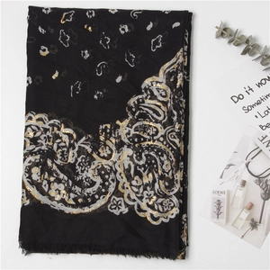 Elegant black paisley scarf with gold foil accents and fringe, lightweight beach wrap