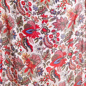 Close-up of lightweight Bali yarn scarf with vibrant red floral and paisley patterns