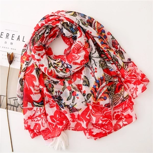 Detail of red and white floral bali yarn shawl with elegant cotton fringe tassels