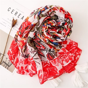 Red and blue floral print cotton scarf with white fringe tassels on white background