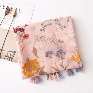 Detail of pink floral linen shawl with silver sequins and colorful tassel fringes