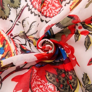 Detailed macro view of lightweight floral print scarf with vibrant red flower pattern