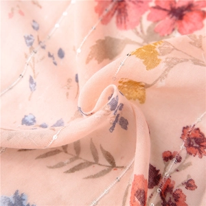 Close-up of floral cotton linen scarf with shiny silver sequins and pink translucent fabric