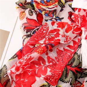 Close-up detail of floral print scarf with intricate patterns and white fringe edges