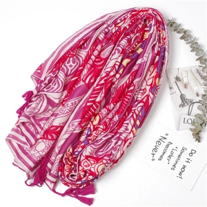 Detail of bohemian geometric print scarf with pink fringe tassels and cotton-linen texture
