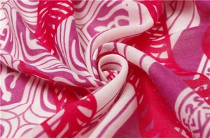 Macro shot of lightweight cotton-linen scarf fabric with vibrant ethnic prints