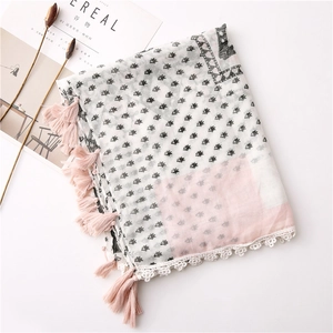 Detail of cotton linen scarf featuring pink tassels, lace edges, and soft geometric prints