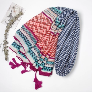Multicolor geometric print beach shawl with pink tassels on a minimalist white background