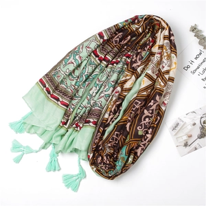 Close-up of mint green beach shawl with bohemian prints and delicate fringe tassels