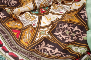 Detailed macro view of soft ethnic scarf fabric with intricate geometric patterns