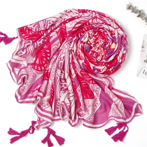 Bohemian style pink and beige printed beach scarf with tassel details on white background
