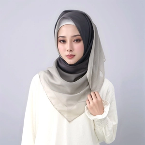 Detail of elegant gradient chiffon hijab transitioning from deep grey to light beige tones