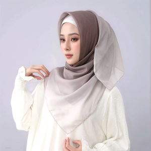 Detail of soft gradient voile hijab showing the smooth brown to light grey color transition