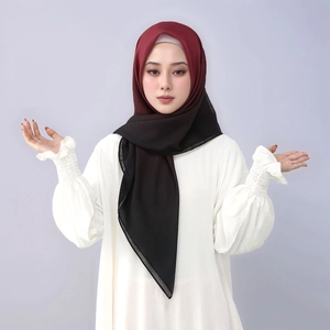 Detail of soft gradient hijab transitioning from deep wine red to black on white blouse