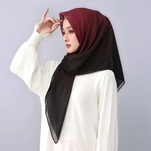 Close-up of lightweight voile hijab featuring a red to black gradient and square texture