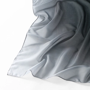 Macro shot of grey gradient scarf fabric with fine stitching and silky texture