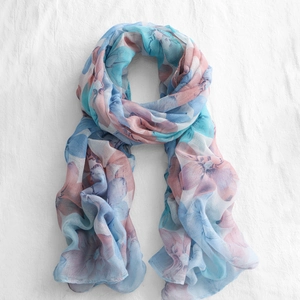 Detail of floral chiffon scarf showing lightweight translucent fabric and light blue patterns