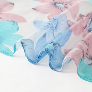 Close-up of floral print sheer voile scarf featuring soft pink and sky blue blossoms