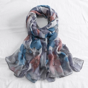 Close-up of lightweight floral voile scarf with soft blue and pink abstract prints