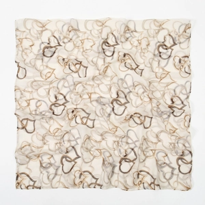 Detail of soft voile scarf featuring elegant interlocking heart print and sheer texture