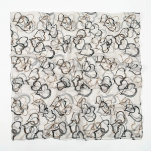 Detail of overlapping heart prints on soft cream-colored bali yarn scarf fabric