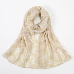 Detail of floral print on beige voile scarf showing lightweight fabric texture and drape