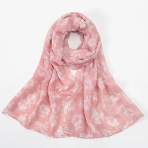 Detail of pink floral print voile scarf with soft semi-transparent hibiscus pattern texture