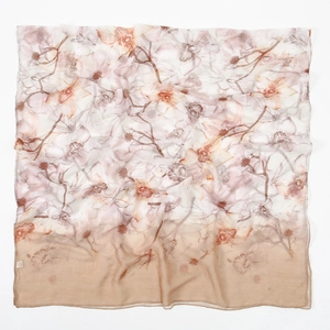 Detail view of lightweight floral chiffon scarf with brown border and orchid pattern