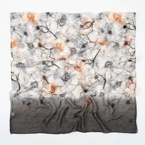 Macro detail of soft floral print fabric with orange and grey gradient textures