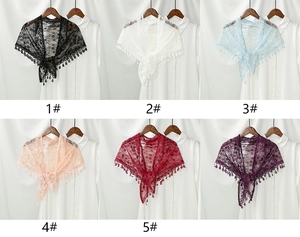 Detailed close-up of colorful floral lace shawls with tassel fringes in six elegant colors