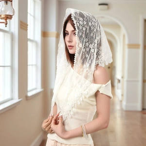 Detail of white lace cathedral veil with floral embroidery and elegant scalloped edges