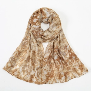 Detailed close-up showing the flat-stitched edges and floral tie-dye print on the soft scarf