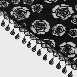 Close-up of black lace fabric with rose patterns and delicate droplet tassel trim