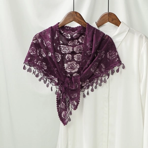 Detail of dark purple lace shawl with rose embroidery and teardrop trim on white shirt