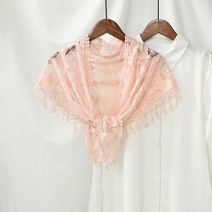 Detail view of pink rose lace bridal shawl with delicate floral patterns and fringe trim