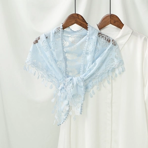 Close-up of light blue floral lace triangle shawl with delicate rose embroidery