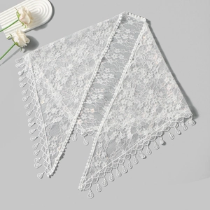 Close-up of white floral crochet lace shawl with sequins and delicate waterdrop fringe