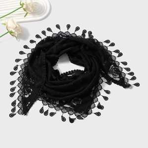 Detail of black lace shawl featuring intricate rose embroidery and teardrop lace trim