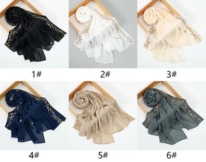 Detail view of ethnic floral embroidered headscarves in six different colors