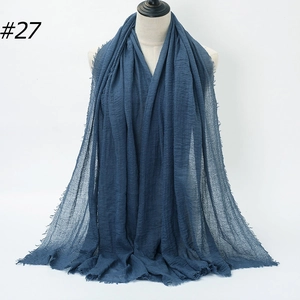Navy blue crinkled cotton hijab scarf with fringed edges on a display mannequin, style #27