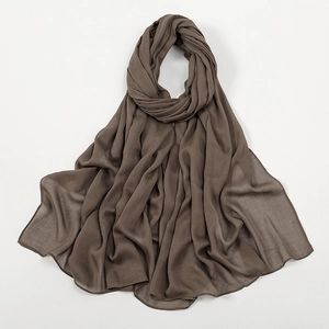Detail of dark brown long scarf fabric showing breathable texture and natural drapes
