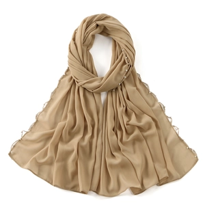 Close-up of beige chiffon scarf featuring elegant white pearl bead trim along the edges