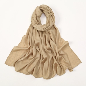 Close-up of champagne satin hijab with sparkling rhinestones and elegant soft drapes